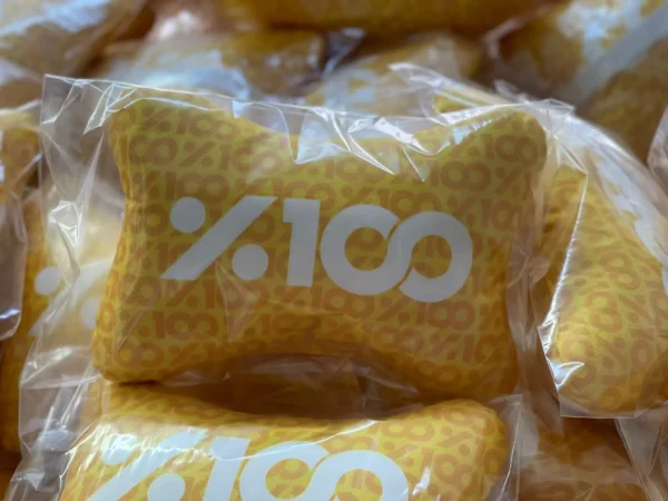 Yellow bone-shaped neck pillow with %100 print in transparent packaging – Textile Promos