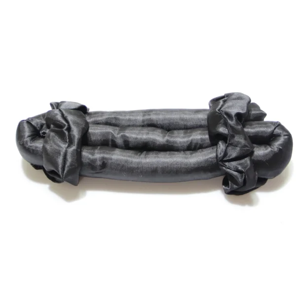 Dark grey satin heatless curling rod with soft rounded ends, laid on a light background