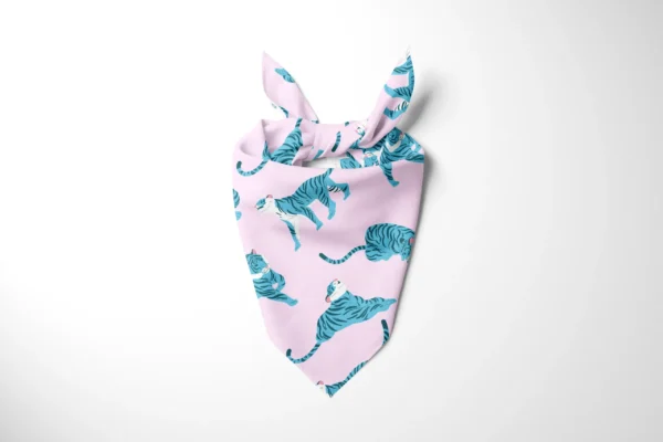 Light pink dog bandana tied at the top, printed with blue tiger illustrations