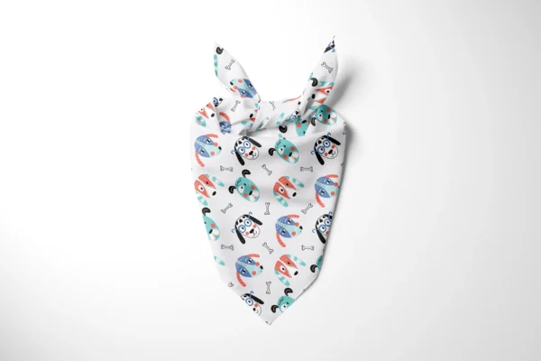 White dog bandana with colorful cartoon puppy faces and bone icons, tied in a knot