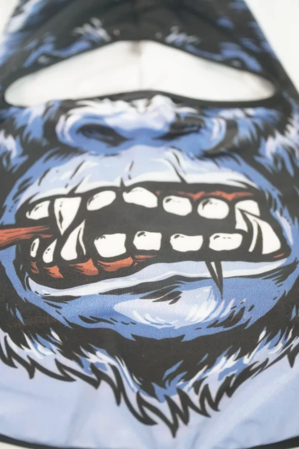 Frontal close-up of custom gorilla print balaclava with vivid teeth and cigar detail – Textile Promos