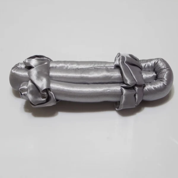 Grey satin heatless curling rod with soft rounded ends on a neutral background