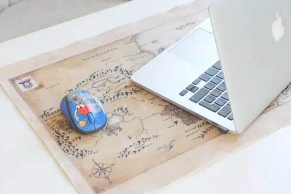 Side view of a fantasy map printed large mouse pad with a laptop and mouse
