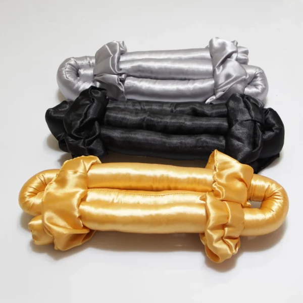 Satin heatless curling rods in silver, black, and gold colors placed on white background