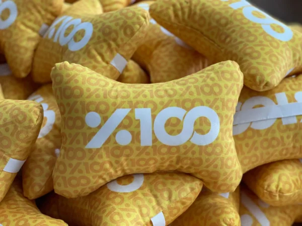 Custom yellow bone-shaped neck pillows with white %100 branding – Textile Promos