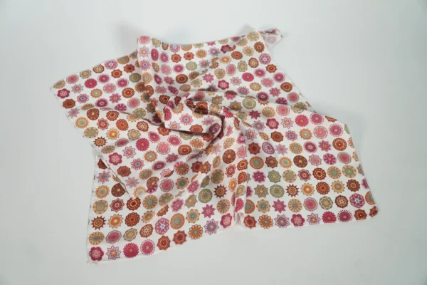 Vivid patterned square scarf loosely folded to show fabric texture – Textile Promos