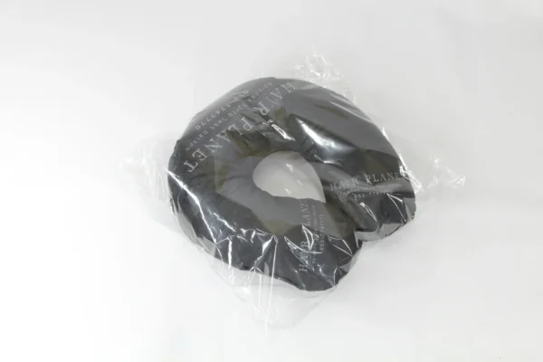 Angled view of black travel neck pillow with custom logo in packaging – Textile Promos